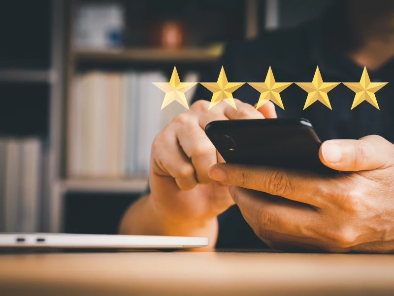 Man's hand holding mobile phone to rating score or survey feedback